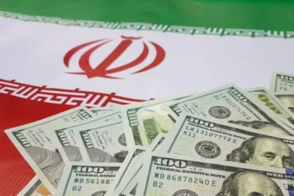 Iranian flag with U.S. dollar bills representing capital flight, state corruption, and economic challenges under sanctions.